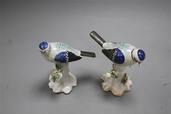 A pair of Derby figures of blue tits on tree stumps, c.1765-70, height 11.7cm and 11.5cm